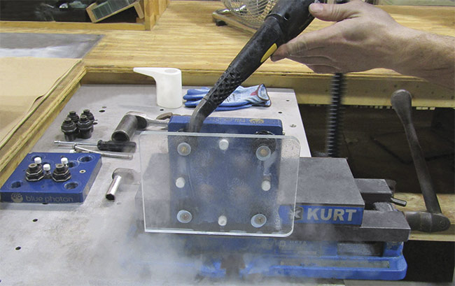 Photo showing the easy debonding a workpiece from the workholding fixture with pressurized steam. Photo courtesy of S.I. Howard Glass Co.
