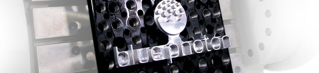 The Blue Photon logo machined into a piece of metal