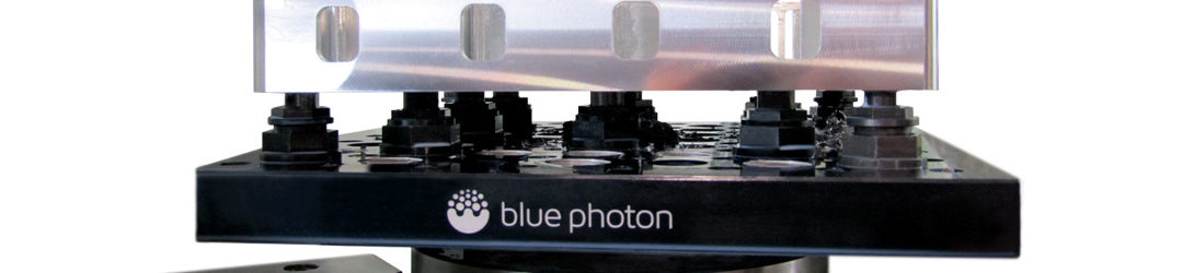 Photo of a Blue Photon gripper fixture securely holding a part