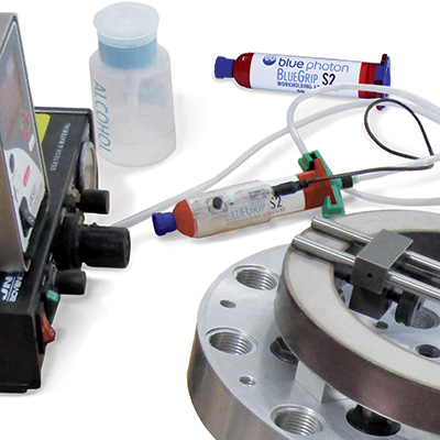Photo of the Blue Photon adhesive dispenser options available for their UV-activated adhesive workholding system
