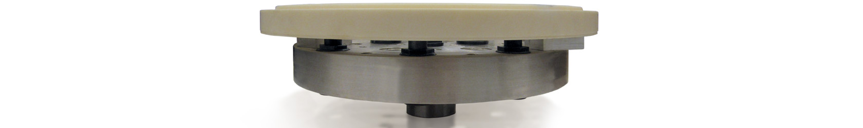 Photo of a ceramic part being held to a Blue Photon workholding fixture